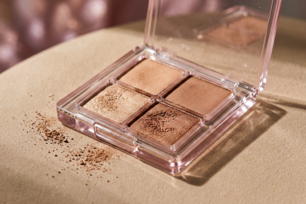 Category anchor: eyeshadow palette / everyday eye makeup / four shades. Photorealistic close editorial still life of one